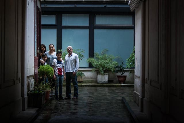 Gabriel, Natalia, Laetitia, Lionel and Noa Syed stand outside in the courtyard of their home, where scores of injured victims sought refuge and underwent treatment after escaping from the Bataclan on 13 November 2015