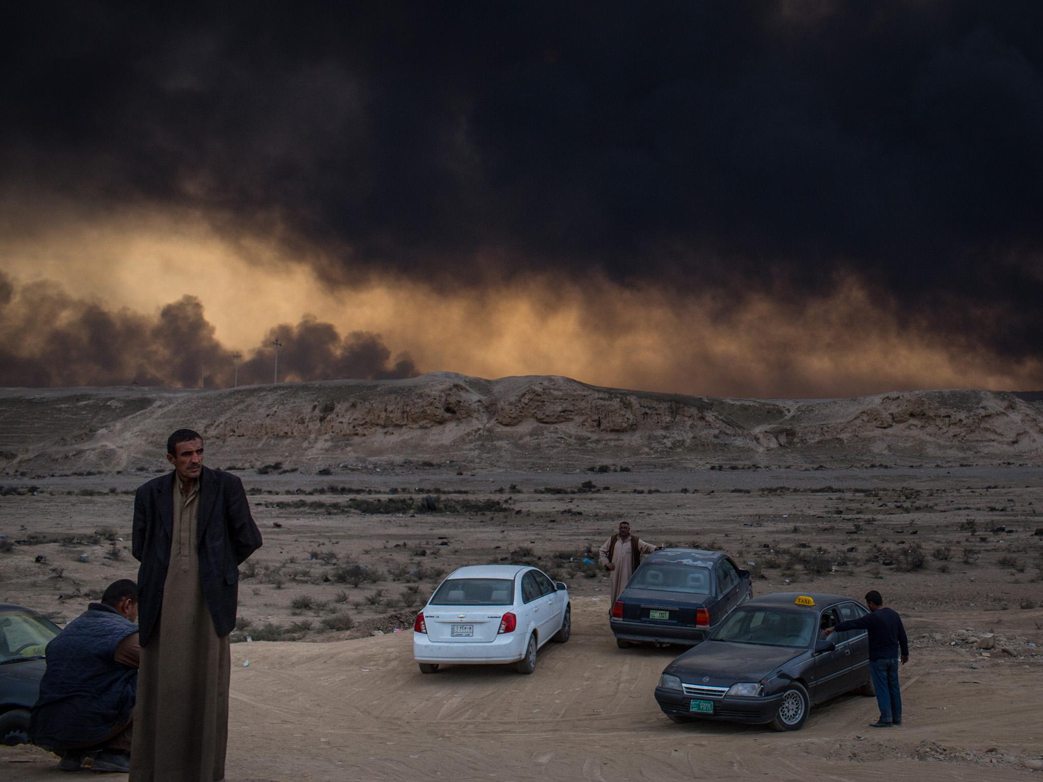 Taxi drivers waiting by the roadside for business against the backdrop of heavily polluted skies