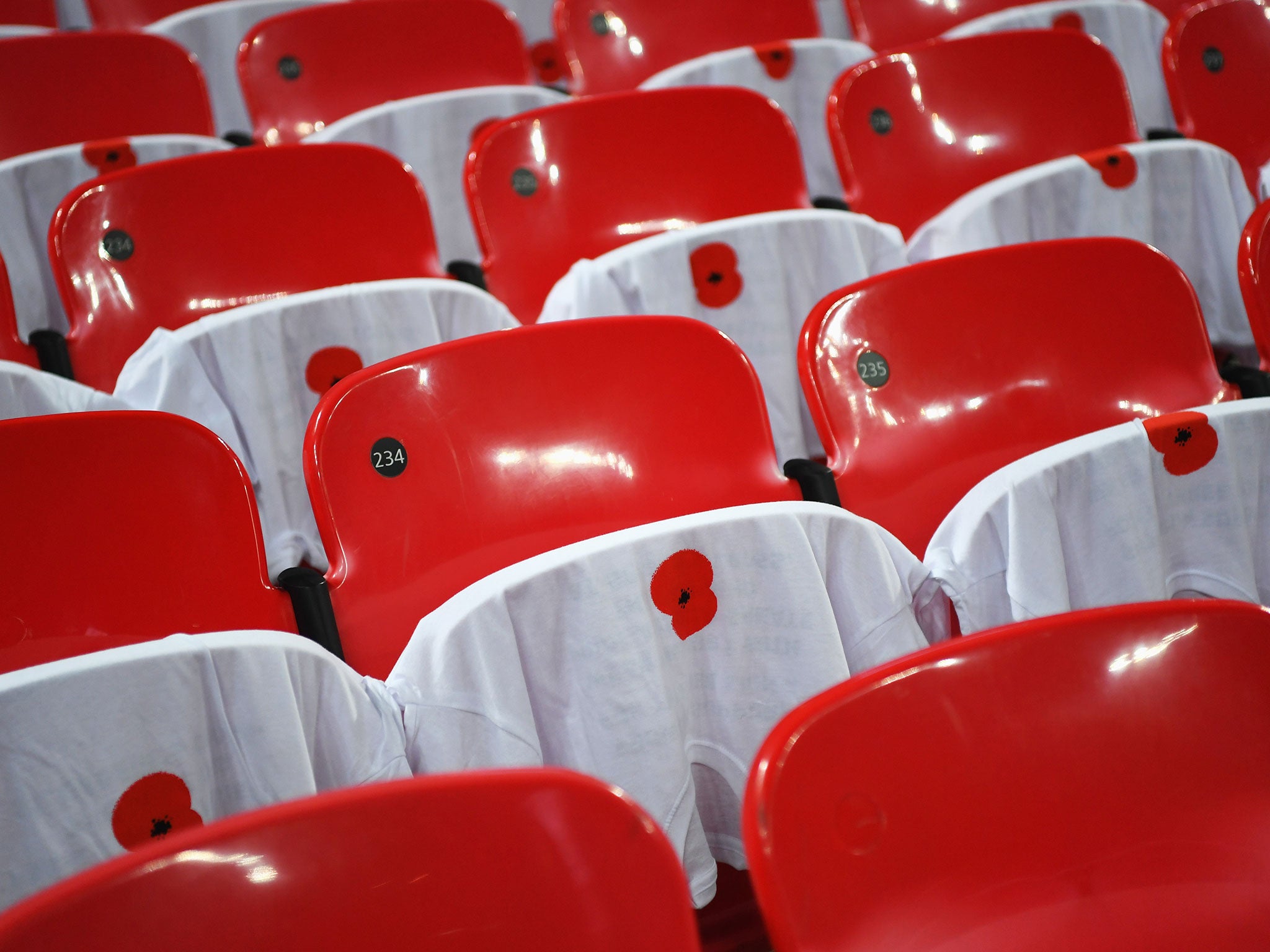 Poppy-emblazoned t-shirts on seats at Wembley