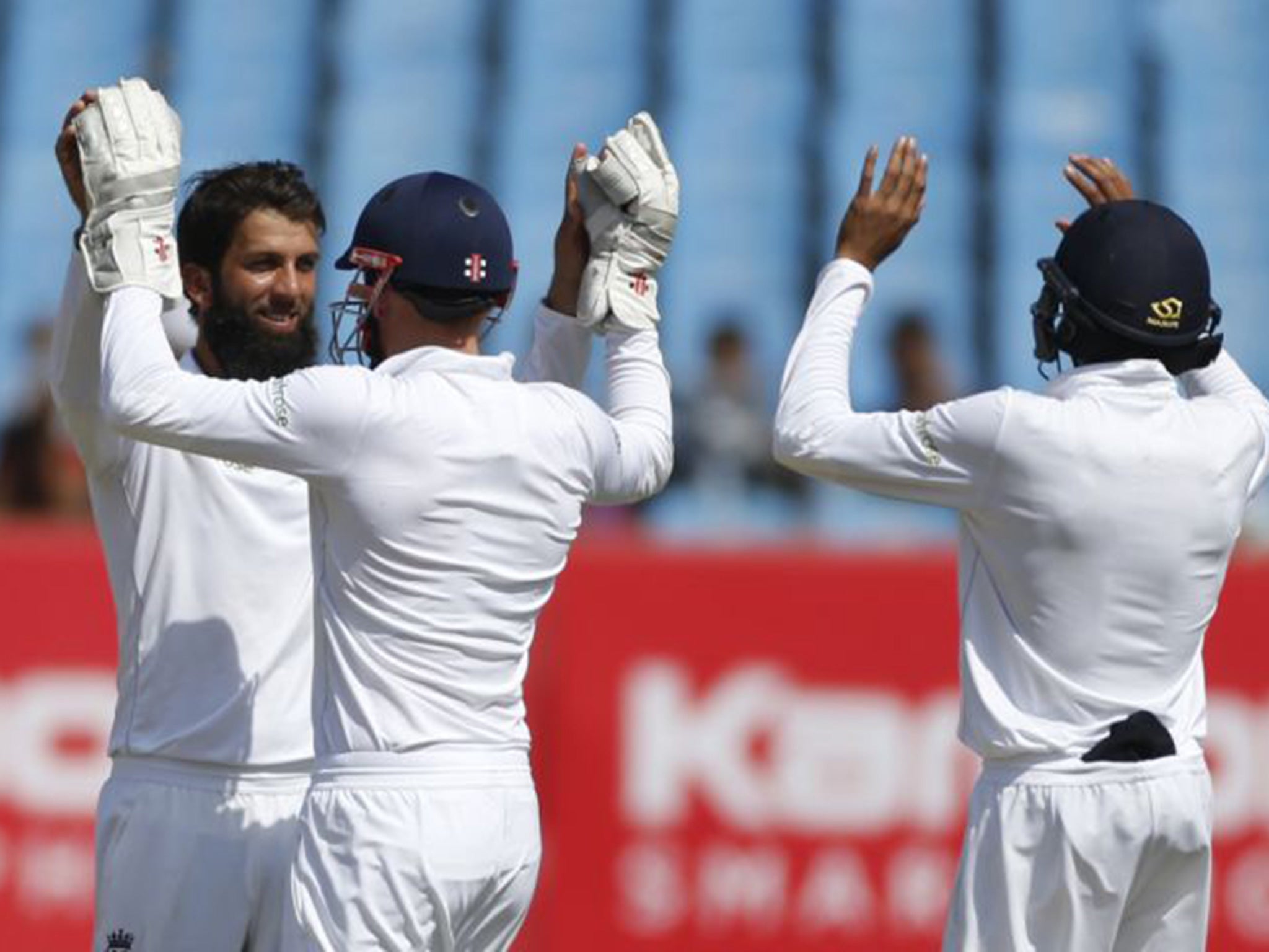Moeen, left, celebrates the wicket of Wriddhiman Saha