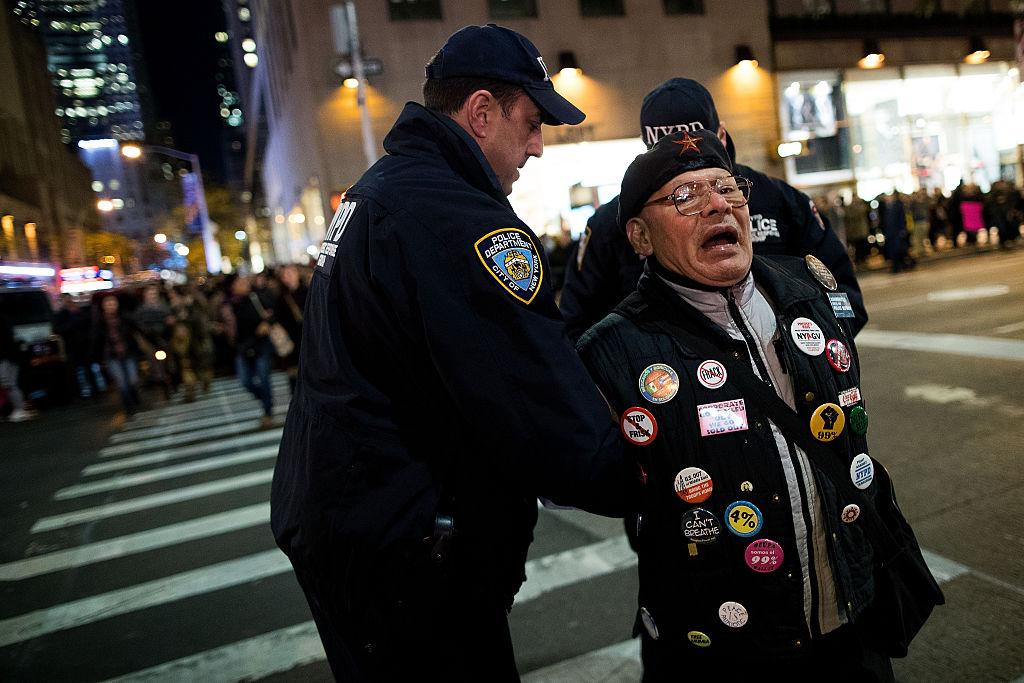 An anti-Trump protester faces off against the Los Angeles Police Department