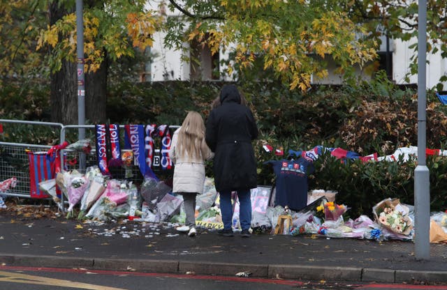 People pay tribute to victims of the tram crash near the scene where a tram crashed