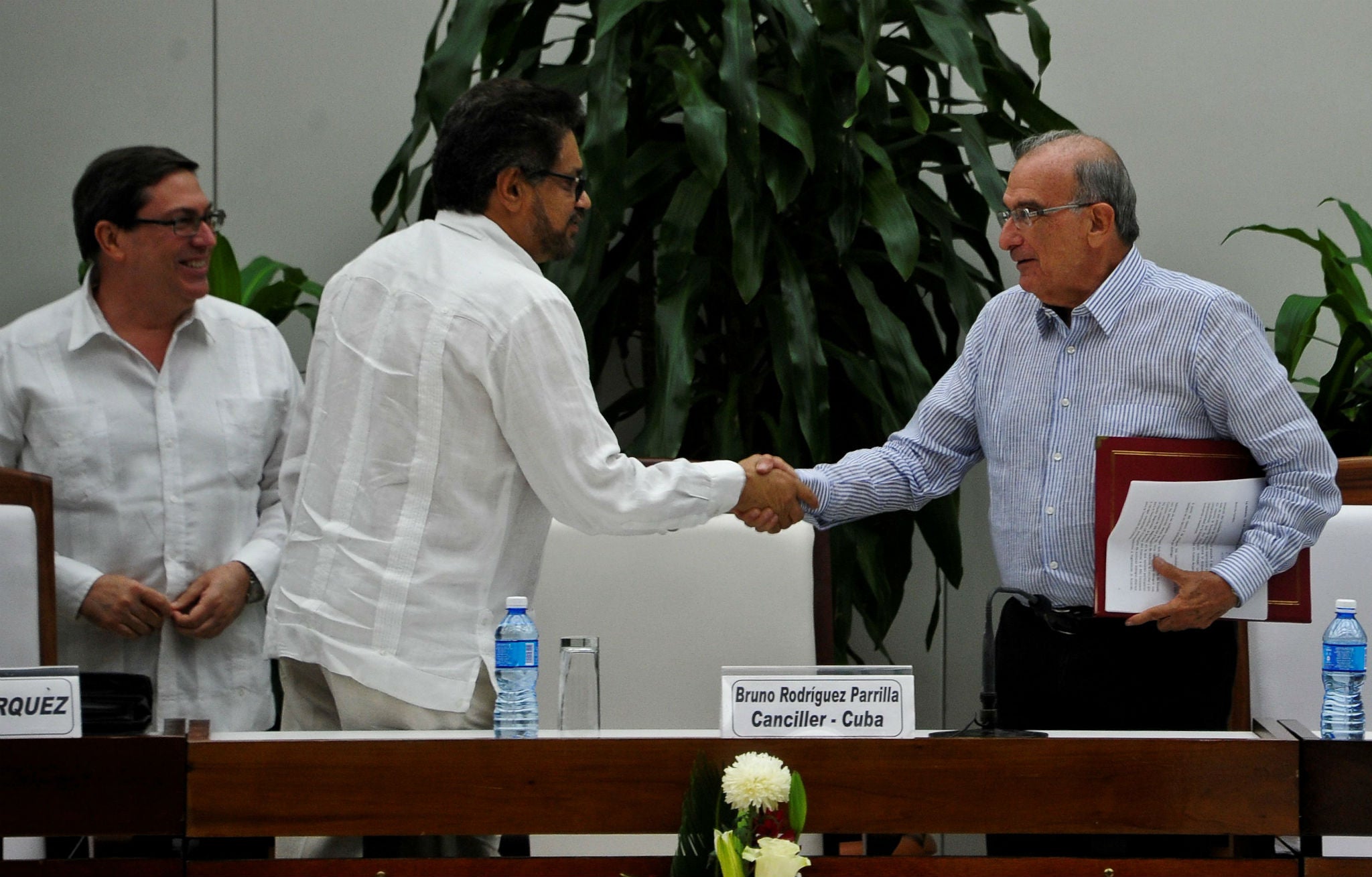 Ivan Marquez (centre) and the head of the Colombian delegation for peace talks Humberto de la Calle (right) shake hands after signing a new peace agreement next to Cuban Foreign Affairs Minister Bruno Rodriguez Parrilla (left) in Havana yesterday