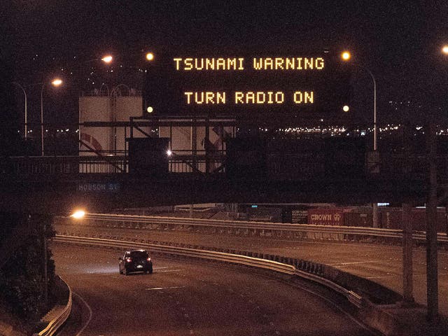 A tsunami warning alert is seen on a notice board above State Highway 1 in Wellington following an earthquake centred some 90 kilometres (57 miles) north of New Zealand's South Island city of Christchurch