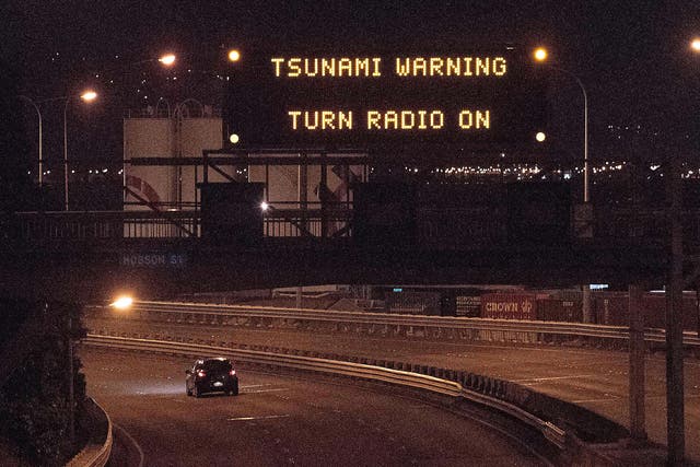 A tsunami warning alert is seen on a notice board above State Highway 1 in Wellington following an earthquake centred some 90 kilometres (57 miles) north of New Zealand's South Island city of Christchurch