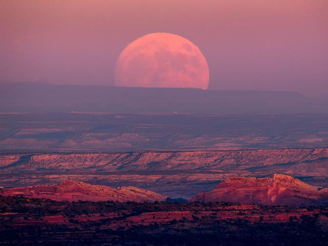 A nearly full moon rises above the Valley of the Gods near Mexican Hat, Utah, USA, 13 November 2016