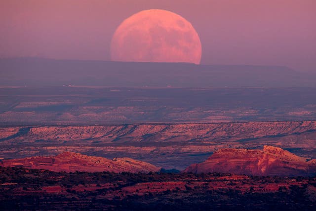 A nearly full moon rises above the Valley of the Gods near Mexican Hat, Utah, USA, 13 November 2016