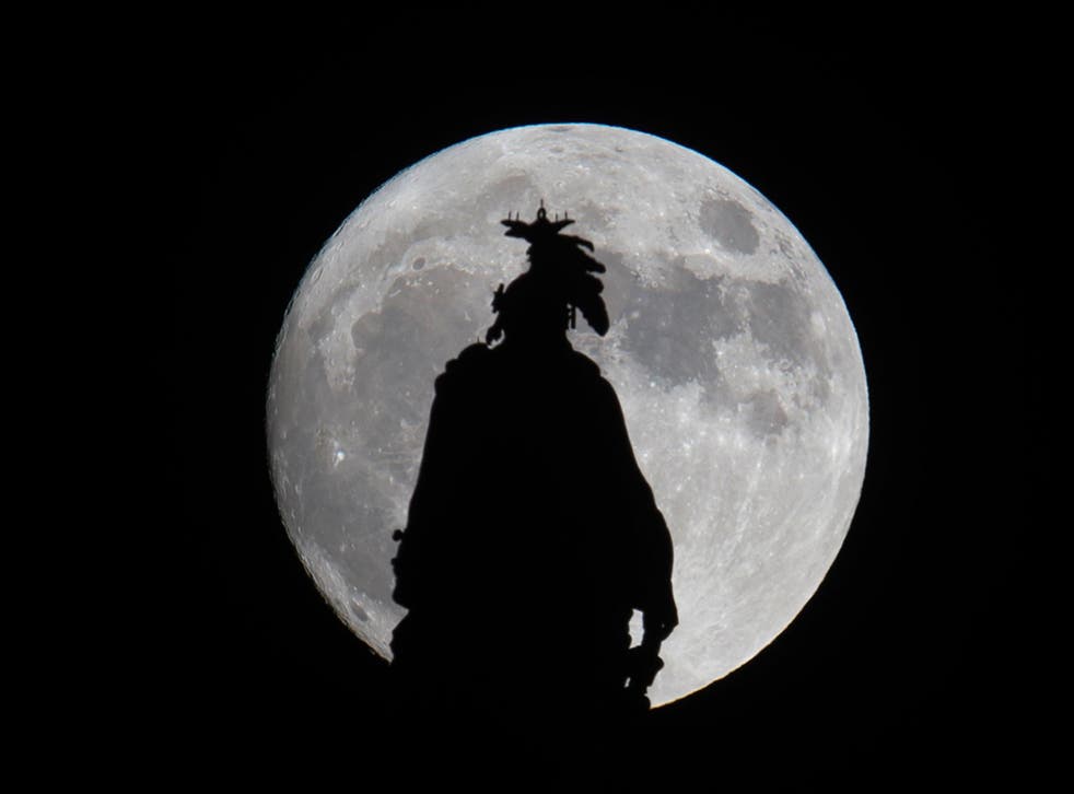 A super moon rises over the Statue of Freedom on the Capitol dome in Washington, DC November 13, 2016.