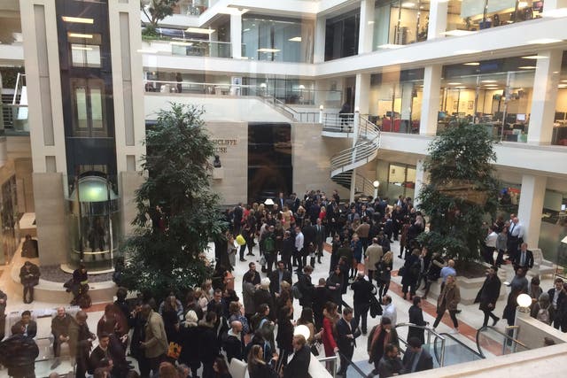 Daily Mail staff gather in the lobby of Northcliffe House after their office was evacuated