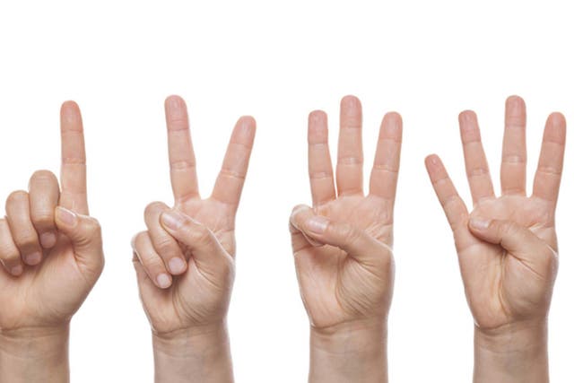 It's not a sign of mental deficiency, counting with your hands is actually a sign of cognitive ability