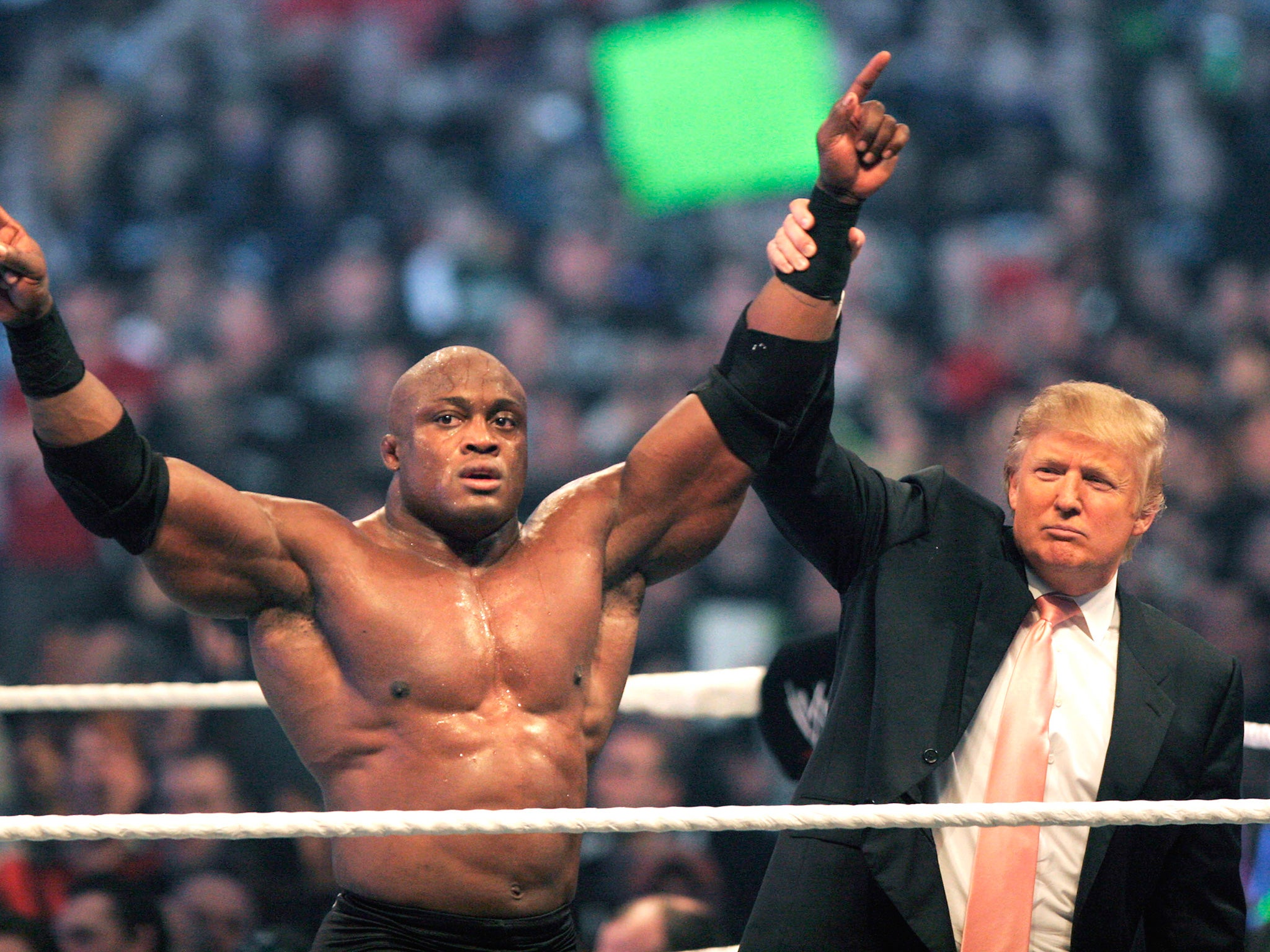 Trump raises the hand of Bobby Lashley after the wrestler's victory over Umaga in the Battle of the Billionaires in 2007