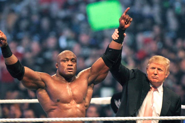 Trump raises the hand of Bobby Lashley after the wrestler's victory over Umaga in the Battle of the Billionaires in 2007