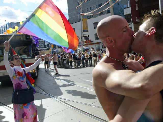 A couple kiss at Toronto's annual Pride Parade