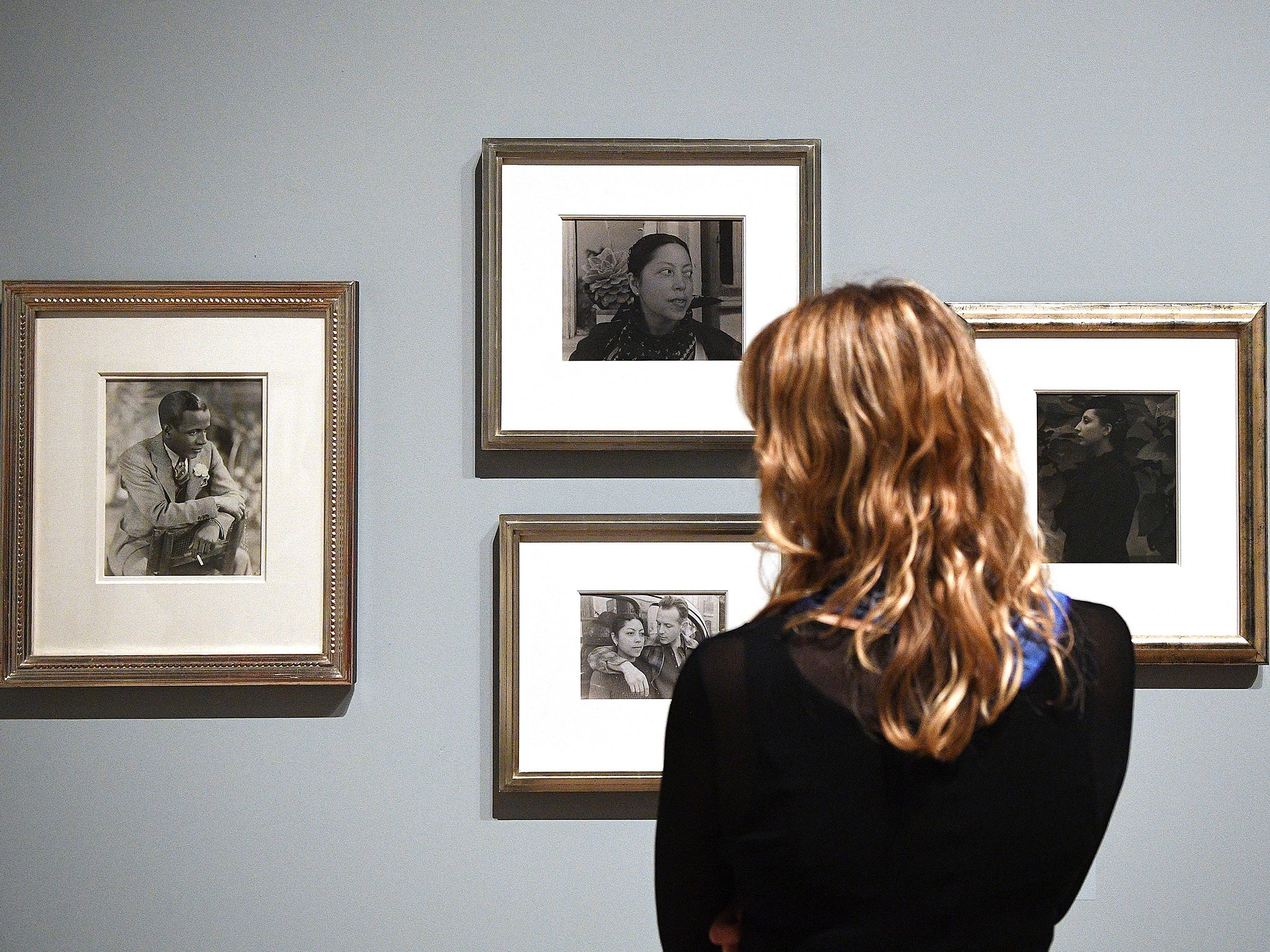 A visitor looks at photographs belonging to the singer-songwriter