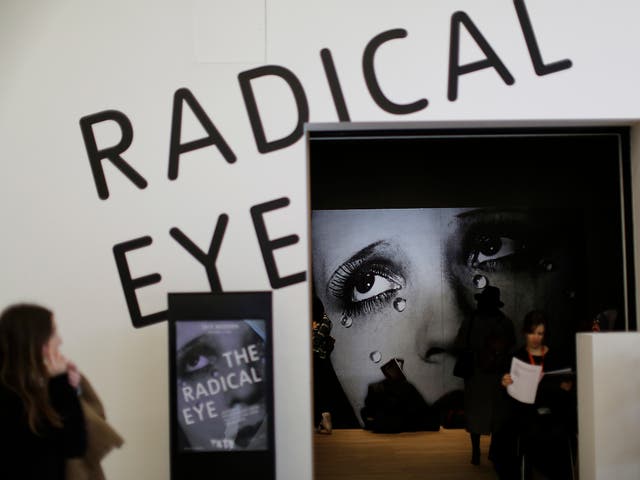A viewer admires Sir Elton John’s collection of photographs at the Tate Modern in London