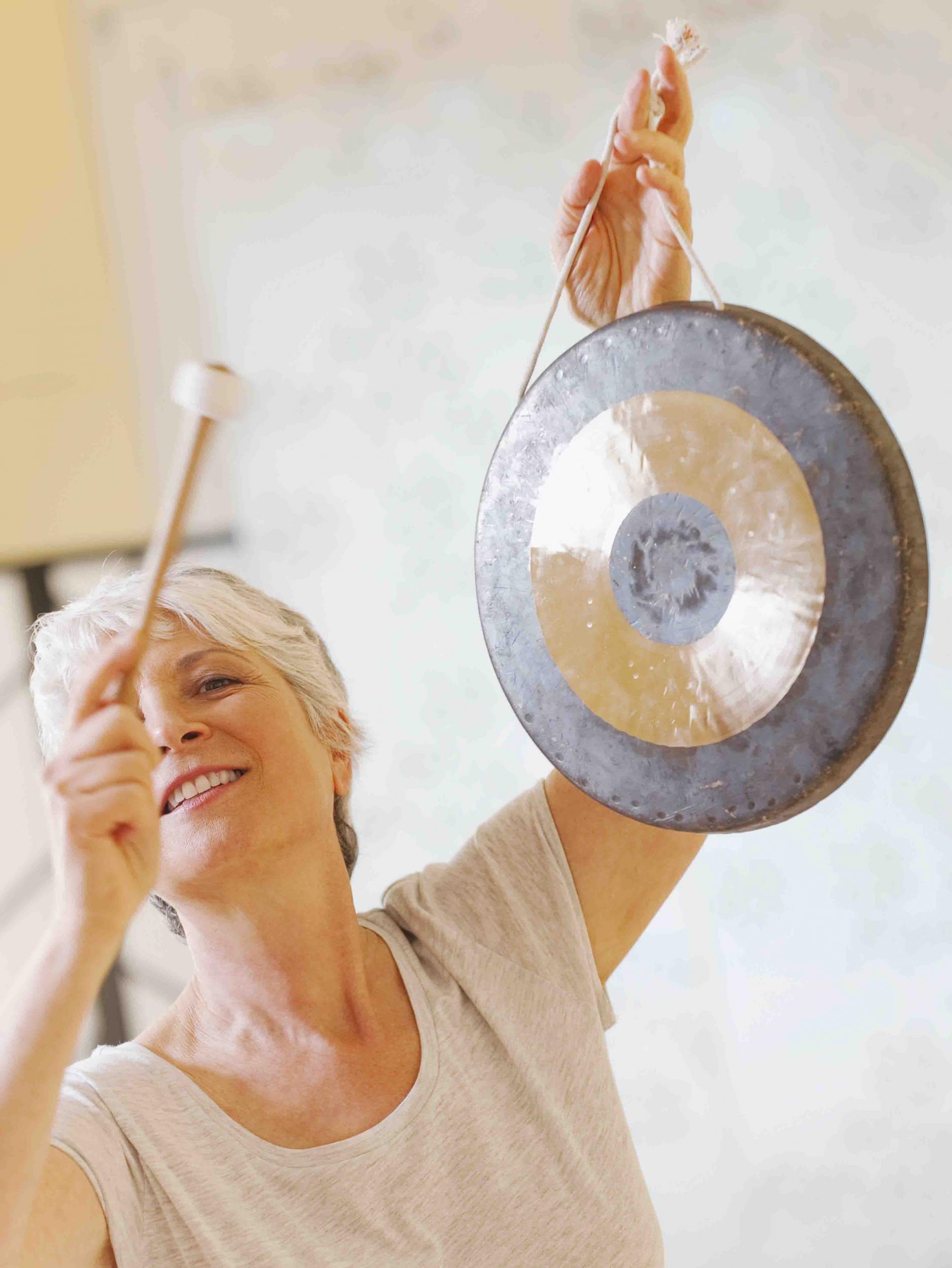 The healer uses traditional instruments such as crystal singing bowls, tuning forks, and gongs