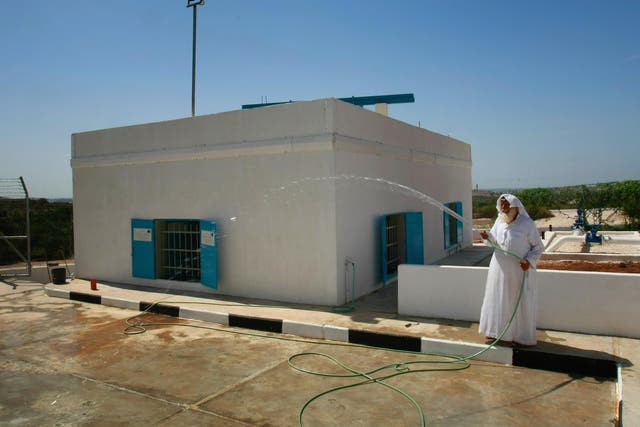 A caretaker tends to a renovated well in the West Bank