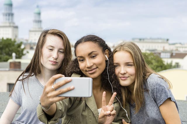 A group of teenagers pose for a selfie. Blood plasma taken from young people could help rejuvenate the brain and other organs of the elderly