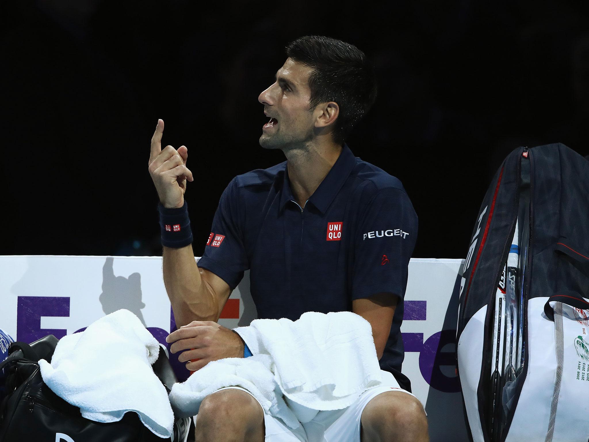 Novak Djokovic argues with the match umpire during his victory over David Goffin