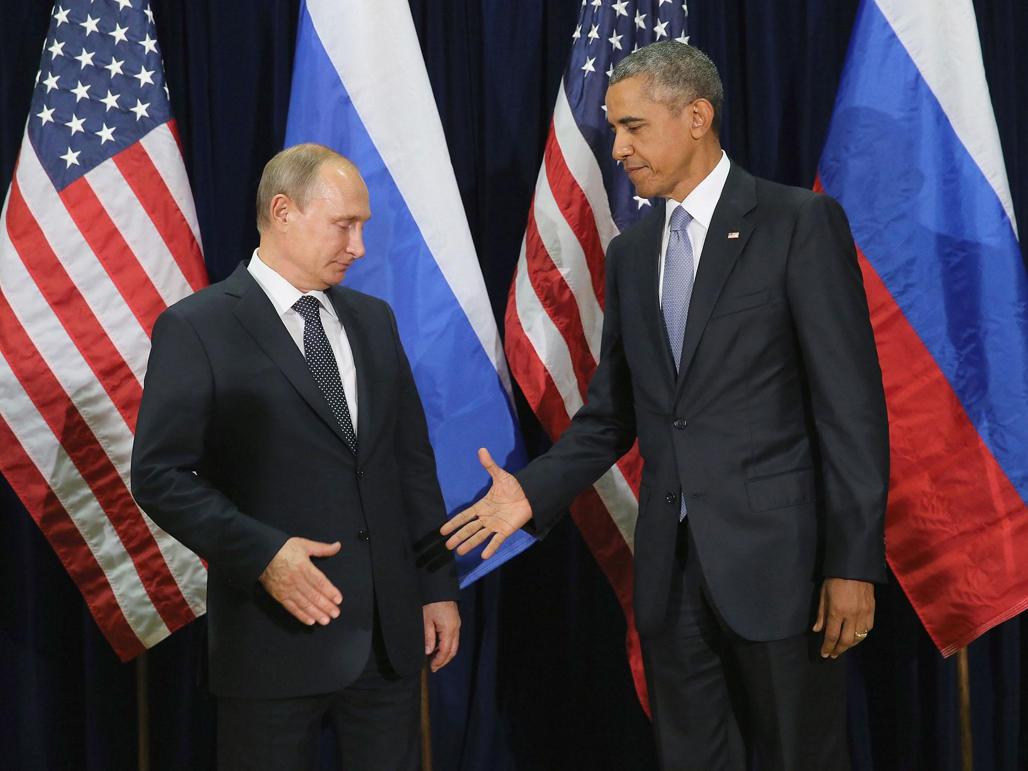 Russian President Vladimir Putin and US President Barack Obama shake hands for the cameras before the start of a bilateral meeting at the United Nations headquarters 28 September, 2015, in New York City