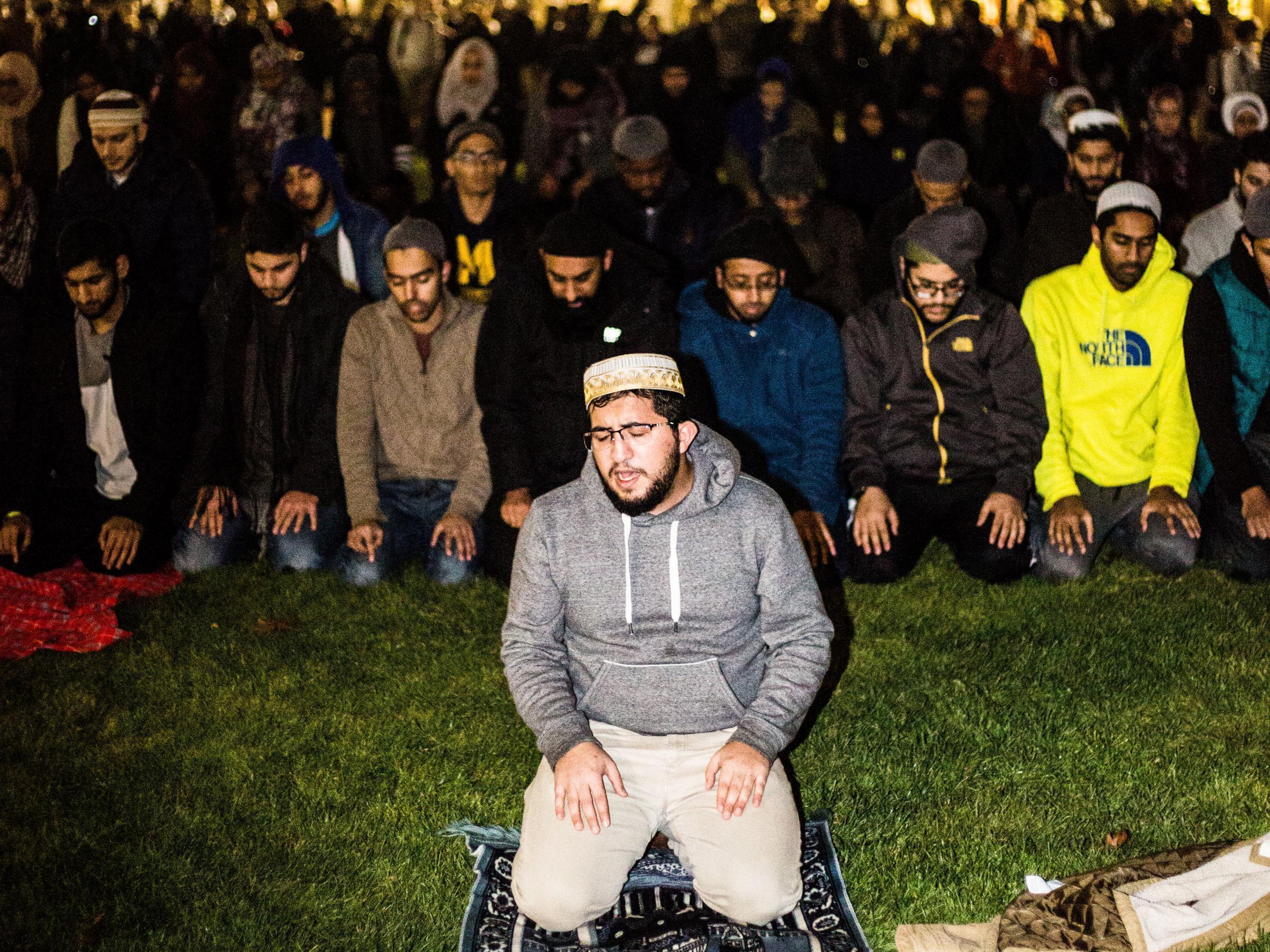 Mohammed Ishtiaq, Michigan University’s Muslim chaplain, leads the Ishaa prayer, while non-Muslim allies form a protective circle around their classmates