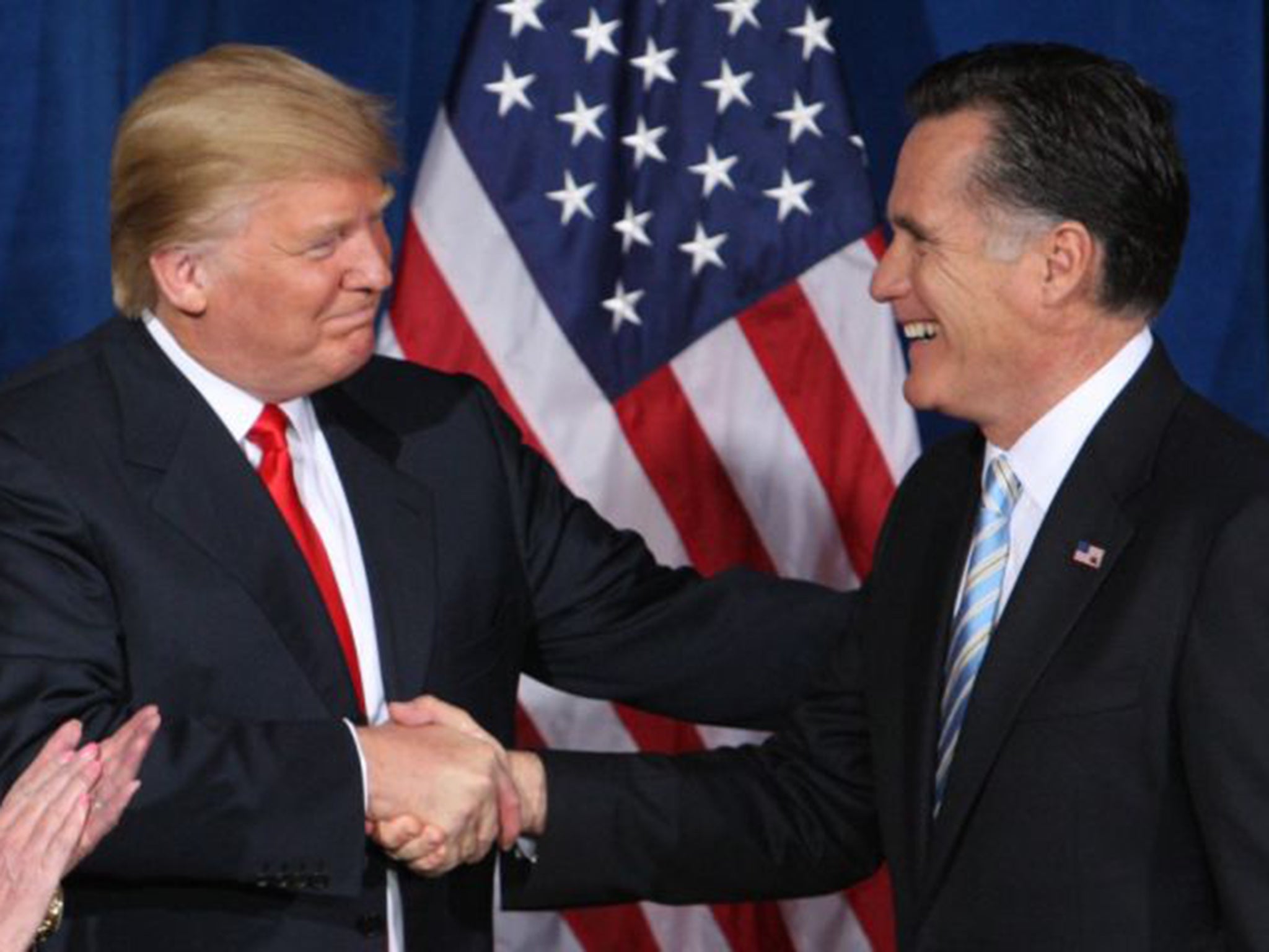 Mitt Romney shakes hands with the man he called a 'fraud' and a 'conman'
