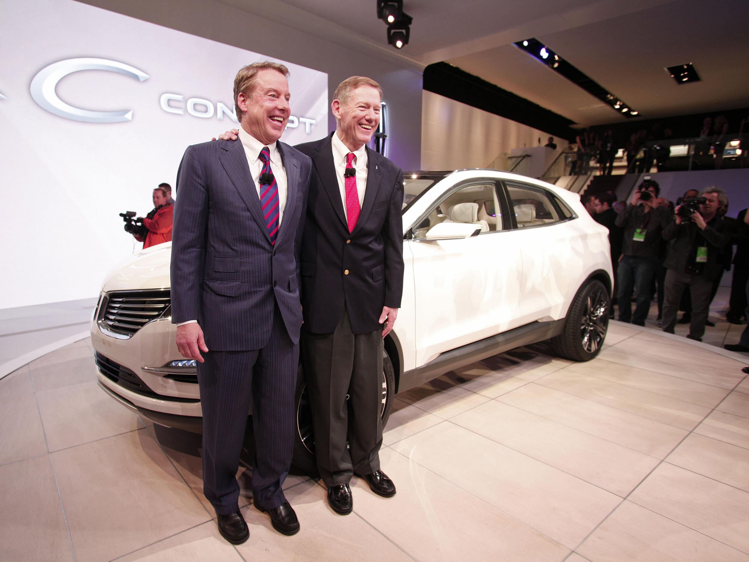 Ford Motor Company chairman Bill Ford (L) and CEO Alan Mulally (R) pose with the Lincoln MKC vehicle at a car show in 2013. Mr Ford confirmed that production of the MKC in Kentucky would not be moving to Mexico, but Donald Trump took credit for saving the entire 'Lincoln plant'.