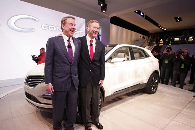 Ford Motor Company chairman Bill Ford (L) and CEO Alan Mulally (R) pose with the Lincoln MKC vehicle at a car show in 2013. Mr Ford confirmed that production of the MKC in Kentucky would not be moving to Mexico, but Donald Trump took credit for saving the entire 'Lincoln plant'.