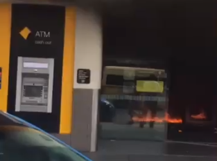 A video posted on Twitter shows the inside of the bank ablaze as people flee