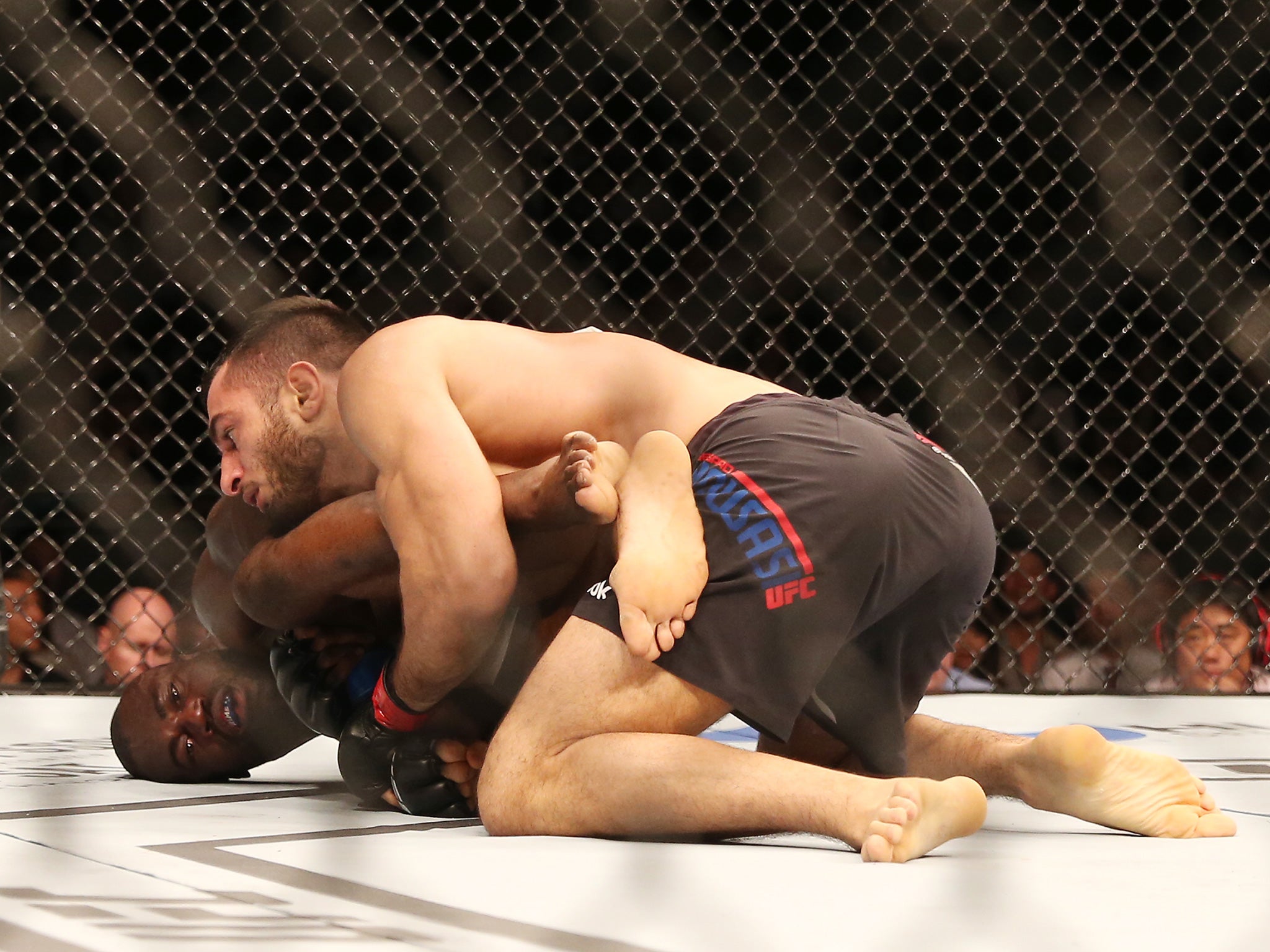 Mousasi, on top, with Hall in the Octagon at UFC Fight Night 75