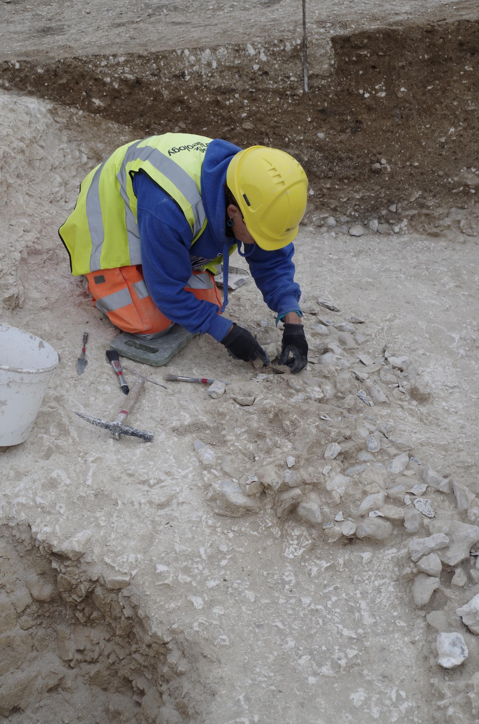 An archaeologist excavates the newly discovered site near Stonehenge