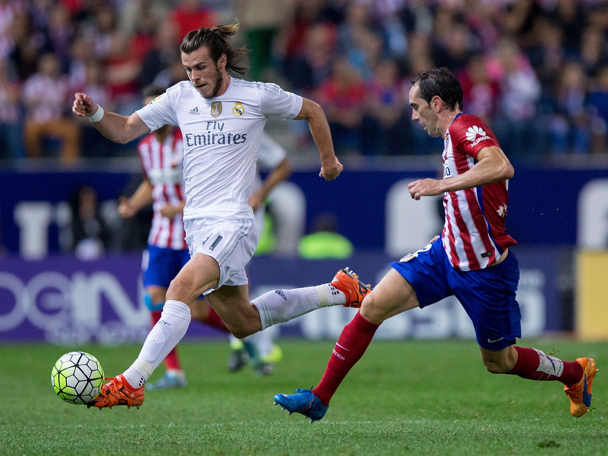 Bale dribbles past Godin in last season's meeting at the Vicente Calderon