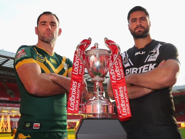 Cameron Smith and Jesse Bromwich, Australia and New Zealand's respective captains, pose with the Four Nations trophy
