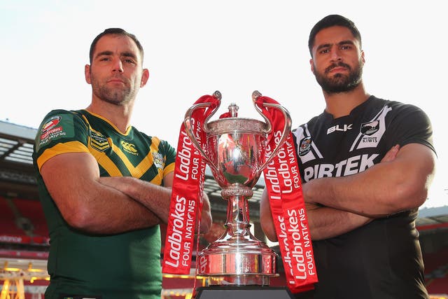 Cameron Smith and Jesse Bromwich, Australia and New Zealand's respective captains, pose with the Four Nations trophy