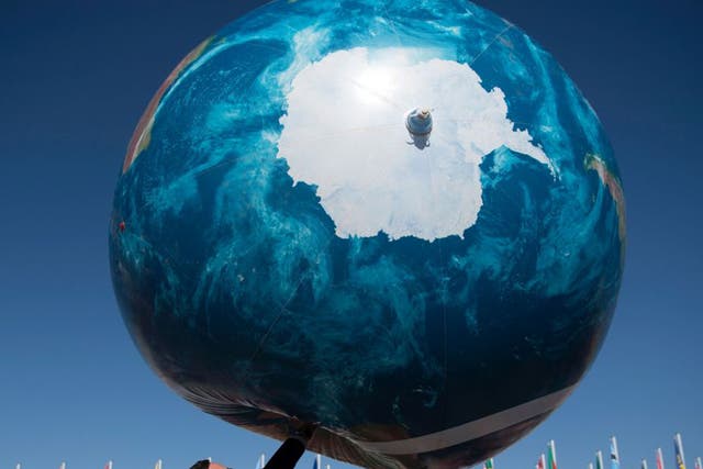 A member of the delegation plays with a giant air globe outside the COP22 climate conference in Marrakesh yesterday
