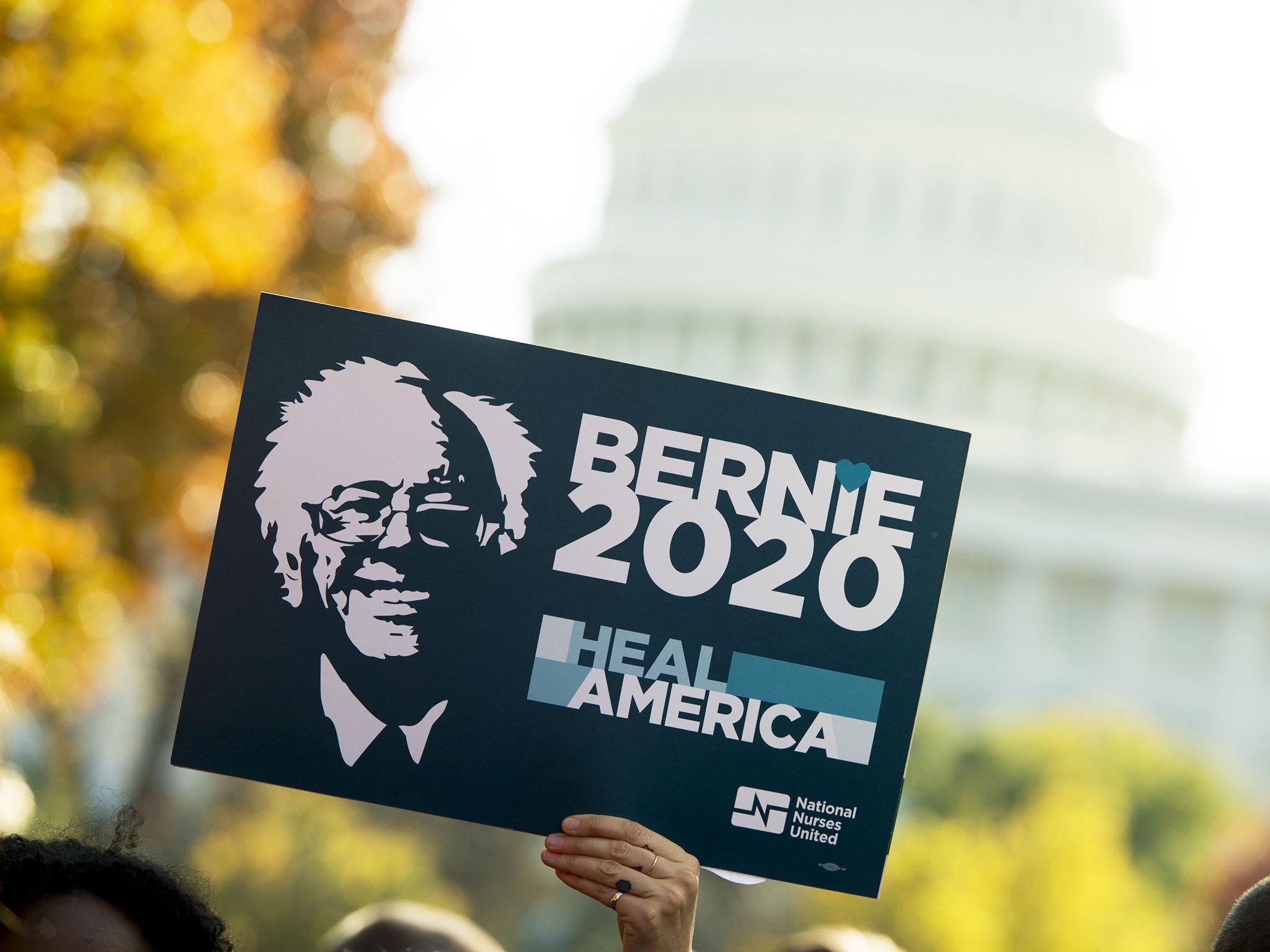 A Sanders supporter holds up a ‘Bernie 2020’ sign as the Senator speaks during a rally on Capitol Hill in Washington DC on Thursday (AFP/Getty)