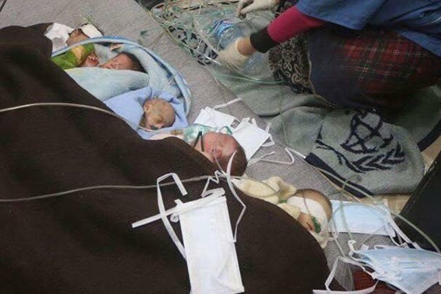 Premature babies removed from incubators and treated on the floor of a civlian home after the bombing of an east Aleppo hospital (
