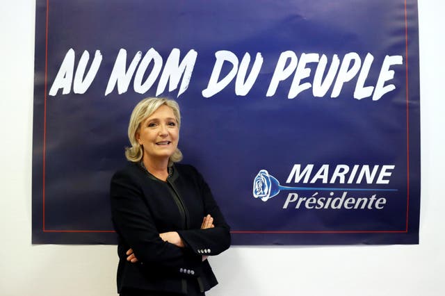 France's far-right National Front (FN) leader Marine Le Pen poses in front of a poster for her 2017 French presidential election campaign as she inaugurates her party campaign headquarters "L'Escale" in Paris, France, November 16, 2016