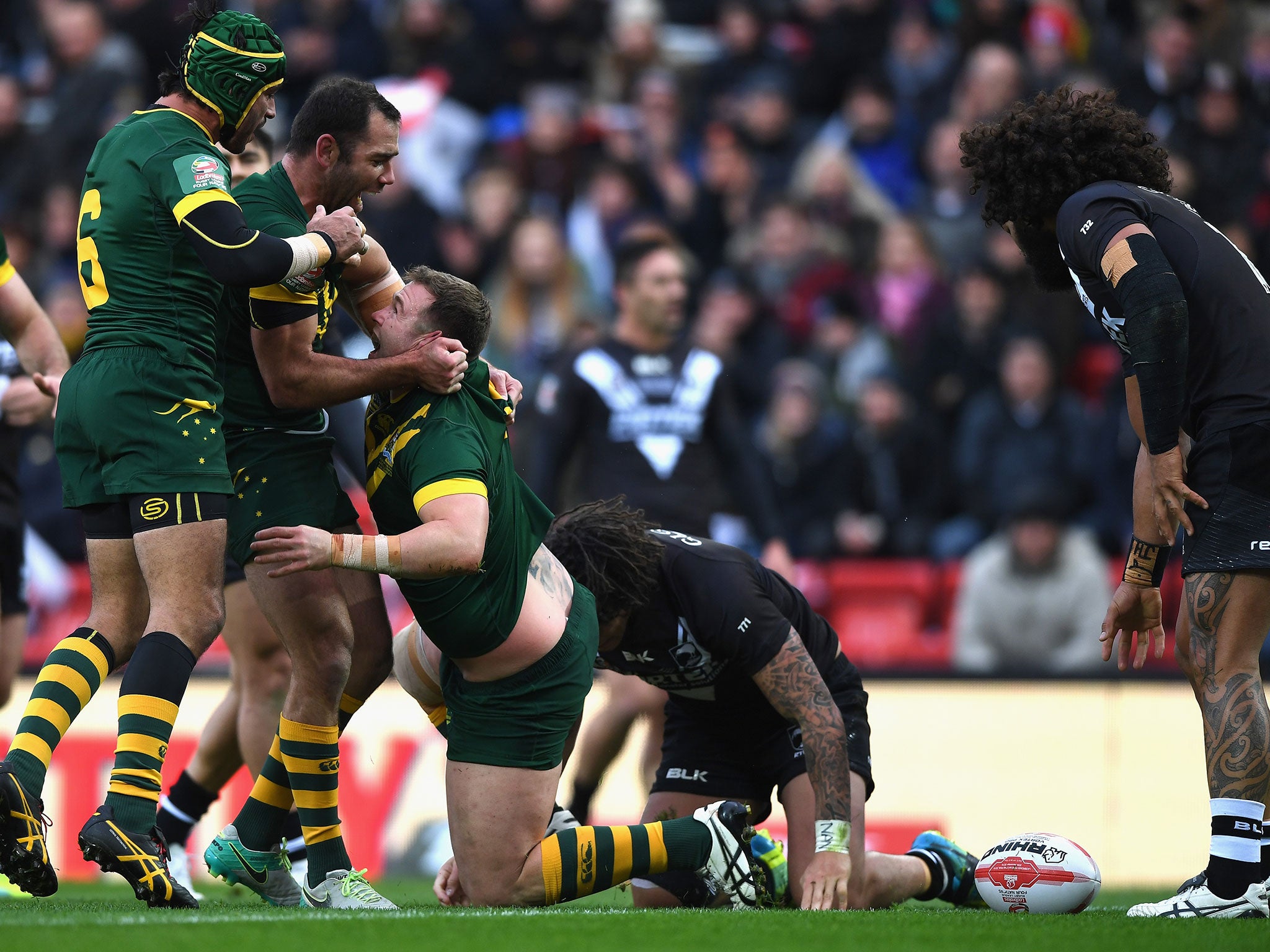 Trent Merrin of Australia celebrates scoring his team's third try with Johnathan Thurston (L) and Cameron Smith