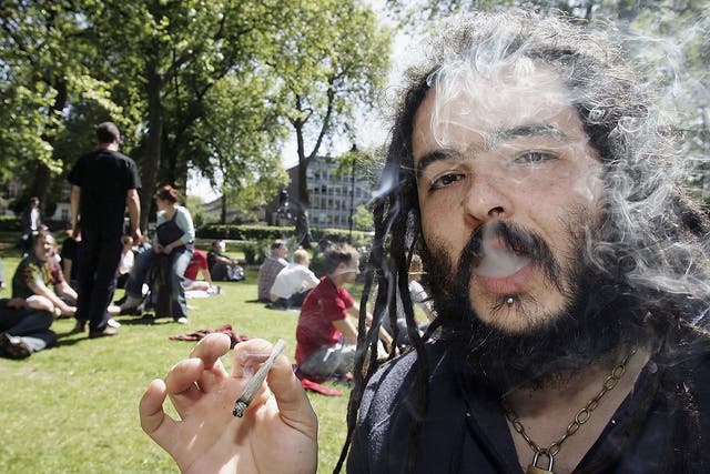 A man smoking a joint in Russell Square, London before a march against the prohibition of cannabis in the UK