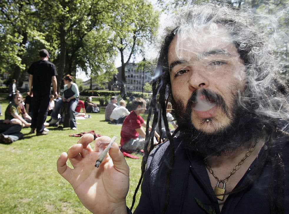 A man smoking a joint in Russell Square, London before a march against the prohibition of cannabis in the UK