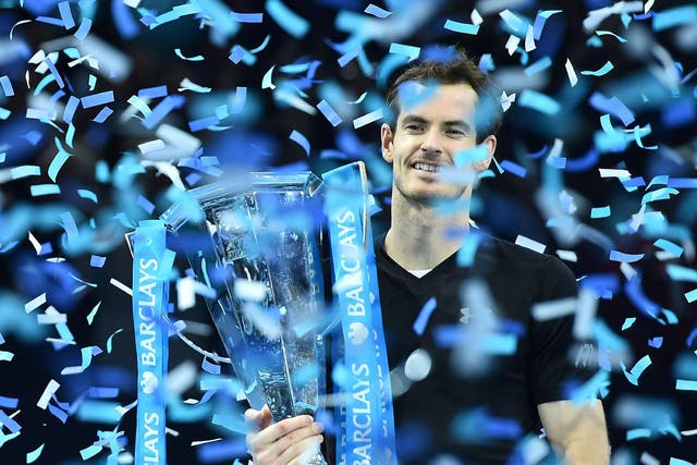 Andy Murray holds the ATP World Tour Finals trophy after beating Novak Djokovic