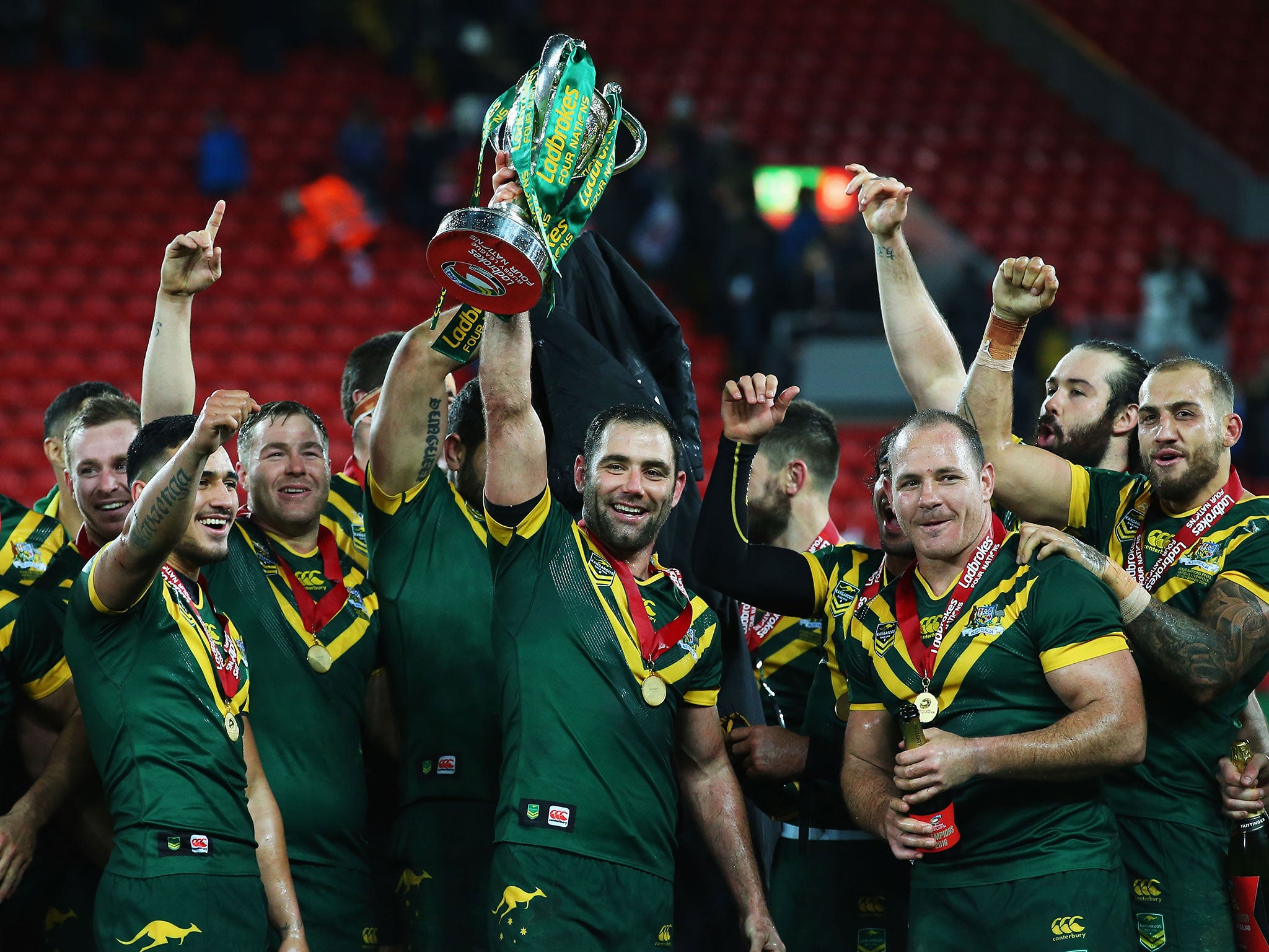 Cameron Smith of Australia lifts the trophy with team mates after victory in the Four Nations Final