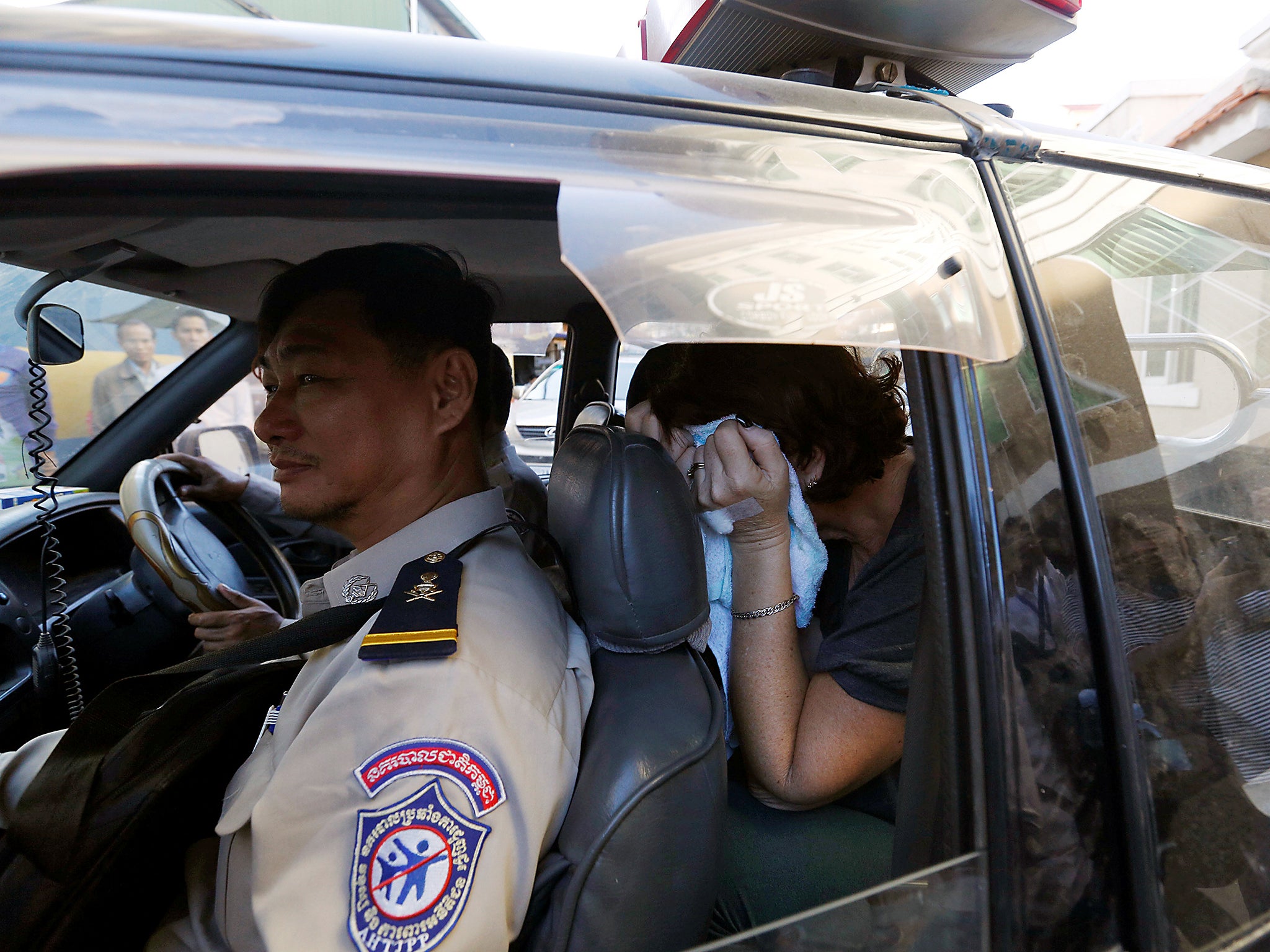 Australia's Tammy Davis-Charles, sits in a police vehicle after appearing for a questioning at the Municipal Court of Phnom Penh, Cambodia