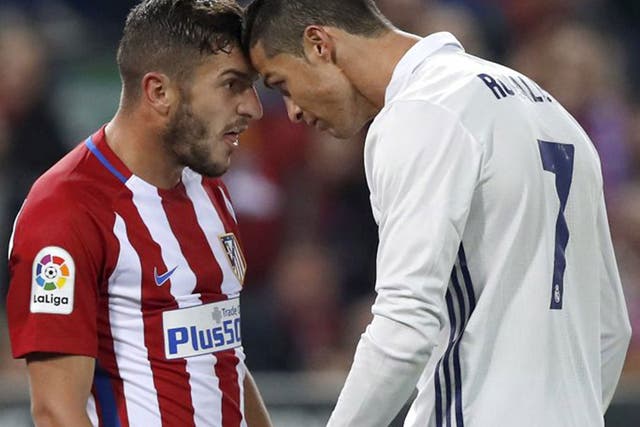Koke and Cristiano Ronaldo clash during the Madrid derby between Real and Atletico