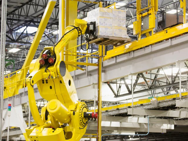 A robotic arm moves merchandise inside an Amazon warehouse in the US