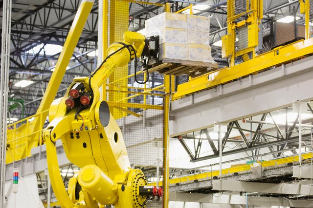 A robotic arm moves merchandise inside an Amazon warehouse in the US