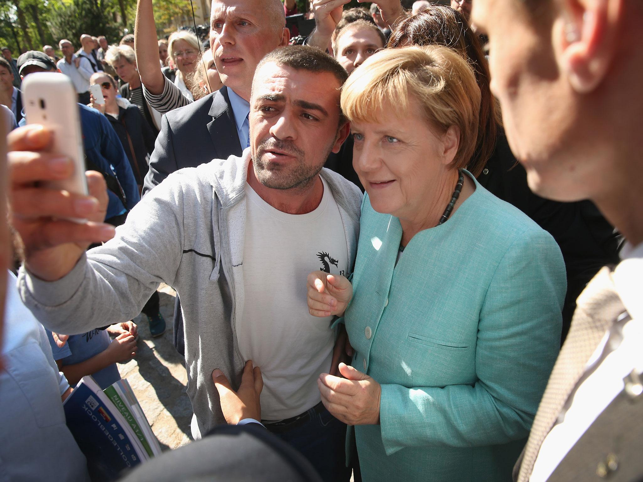 German Chancellor Angela Merkel paused for a selfie with a refugee after she visited the AWO Refugium Askanierring shelter in Berlin, Germany, on 10 September, 2015