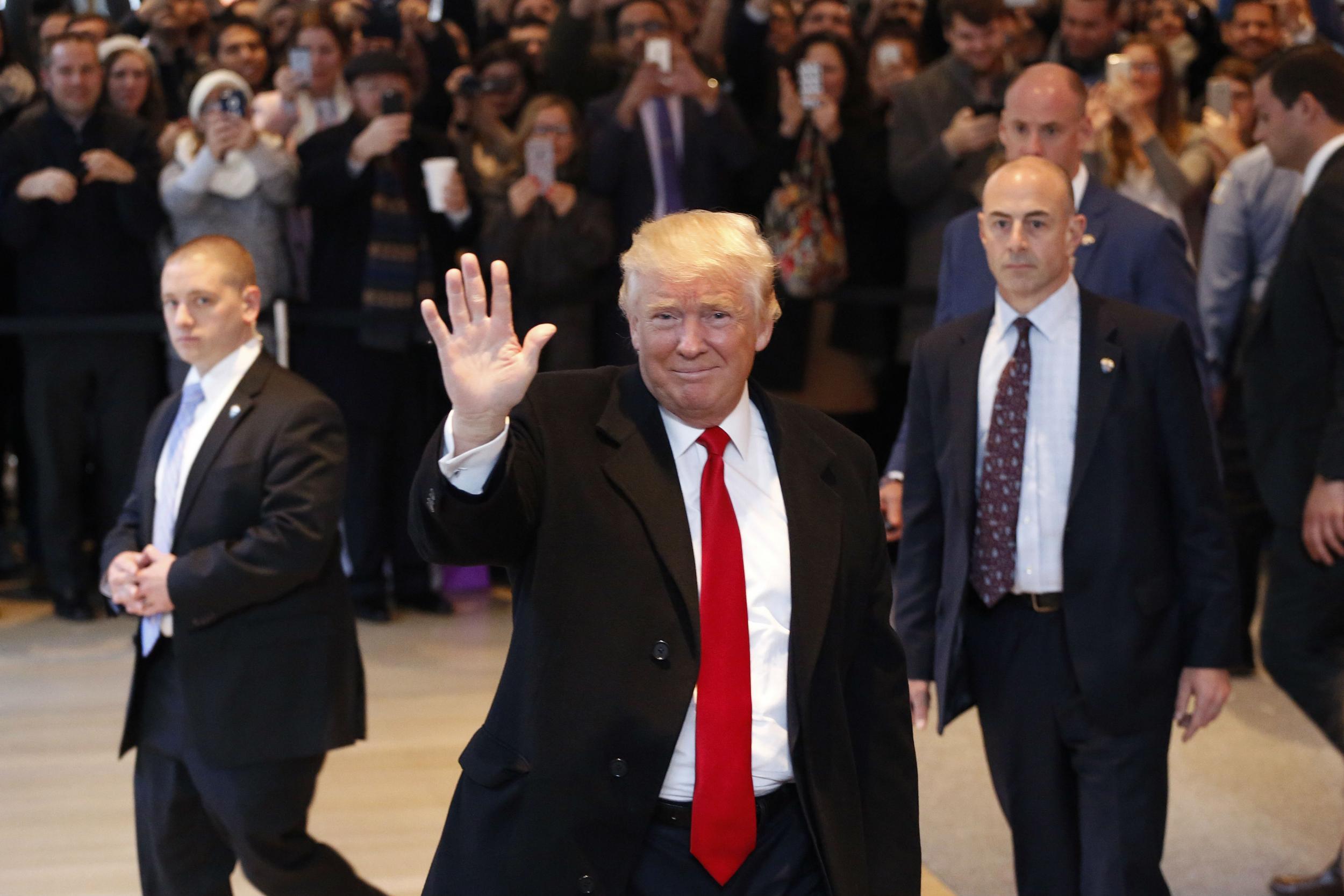 Donald Trump being booed on his way into a meeting with the New York Times in November 2016