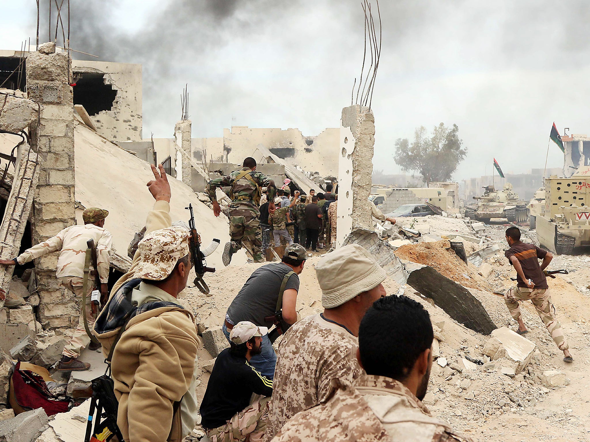 Forces loyal to Libya's Government of National Accord (GNA) hold a position amid the rubble of destroyed buildings in Sirte's Al-Giza Al-Bahriya district
